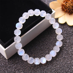Natural Moonstone Lotus Love Bracelet - 45-degree view with flower prop in gift box, healing bracelet