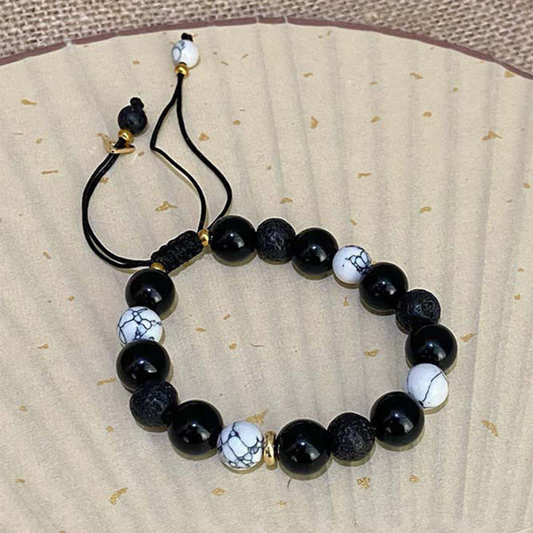 Black Obsidian Lava Rock Yin Yang Bracelet – Adjustable black cord bracelet on gold-flecked paper, unisex natural stone be...