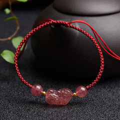 Strawberry Quartz PiXiu Red Bracelet – dark surface display, red braided cord pink quartz beads, love luck