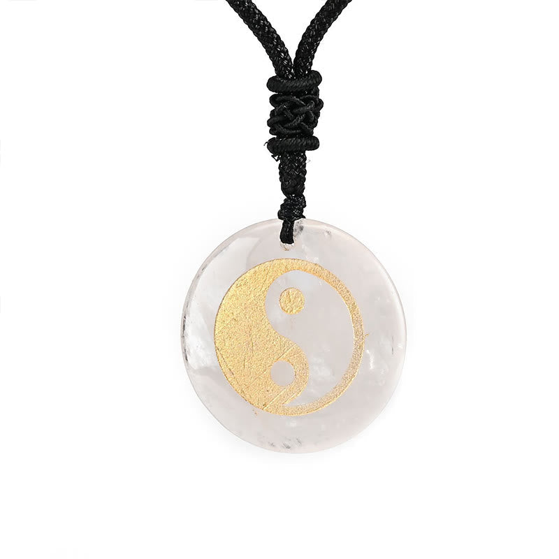 Yin Yang Crystal Necklace – Clear quartz pendant with gold yin-yang on black cord, round polished stone with natural crystall