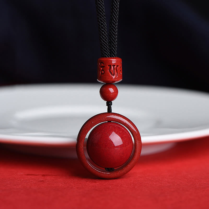 Cinnabar PiXiu Necklace – Black cord version by white plate on red table, alternative style blessing necklace