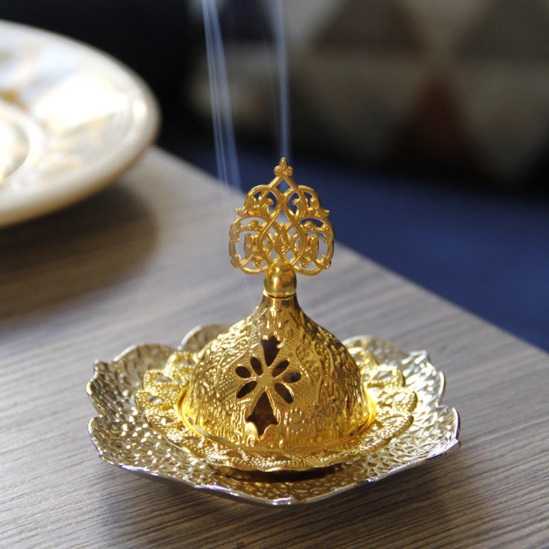 Gold Leaf Coaster Incense Burner with smoke wisps on light wood, lotus base detail, alloy incense holder