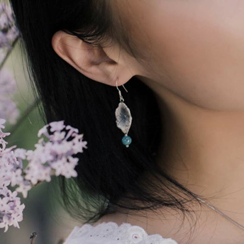 Sterling Silver Turquoise Lotus Leaf Earring - worn on ear with lavender, feminine style