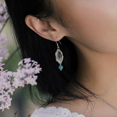 Sterling Silver Turquoise Lotus Leaf Earring - worn on ear with lavender, feminine style