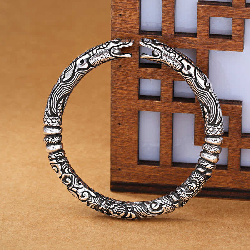 Dragon Head Carved Luck Bangle – dual dragon head cuff on lattice screen, Antique Silver
