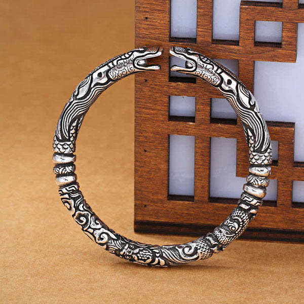 Dragon Head Carved Luck Bangle – dual dragon head cuff on lattice screen, Antique Silver