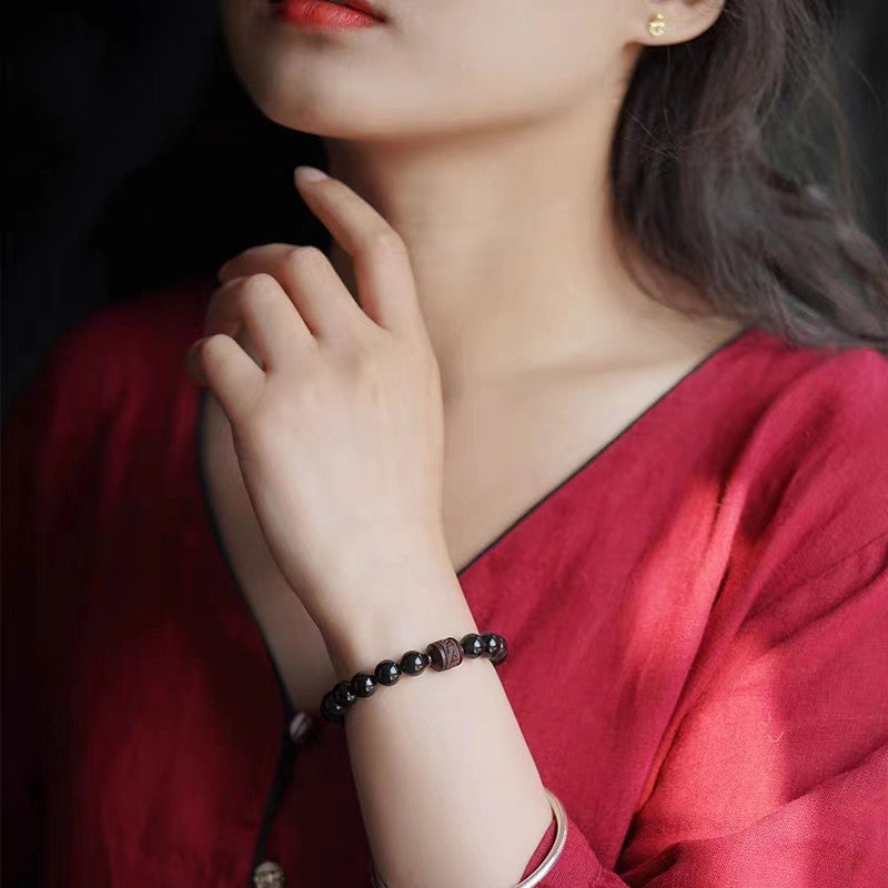 Gold Sheen & Rainbow Obsidian Fu Bracelet – close-up worn with red top and gold earring, bead jewelry