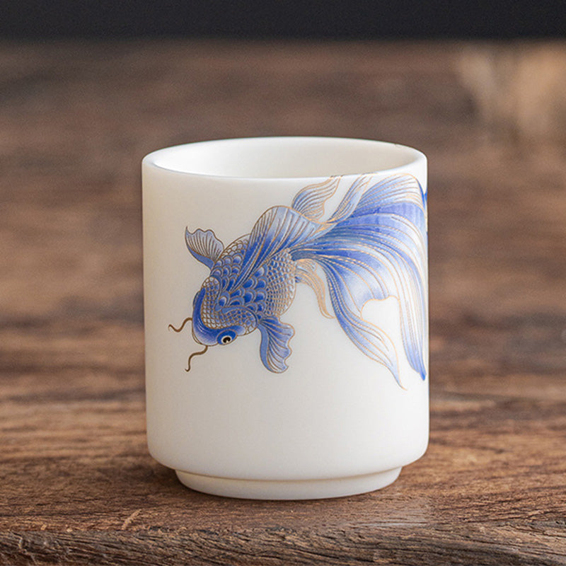 Koi Fish Porcelain Cup - studio shot on dark backdrop, koi colors pop against white