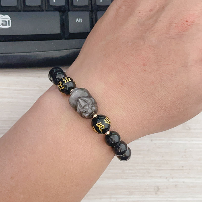 Silver Sheen & Black Obsidian PiXiu Bracelet – wrist-worn view revealing carved stone Pixiu and gold character beads, blac...