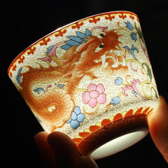 2Pcs Dragon Phoenix Ceramic Teacup Set - Translucent dragon cup backlit against black, exquisite