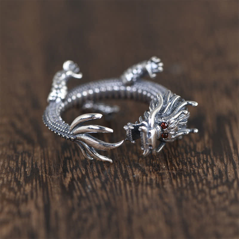 925 Sterling Silver Dragon Ring – Three-quarter elevated view of dragon head and scaled body on dark wood, Protective