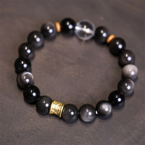 Silver Sheen Obsidian Mantra Bracelet – flat lay showing obsidian beads with gold cylinder charm, crystal bracelet