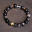 Silver Sheen Obsidian Mantra Bracelet – flat lay showing obsidian beads with gold cylinder charm, crystal bracelet