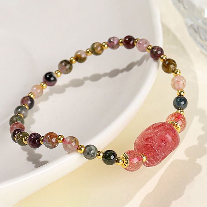 Moonstone Strawberry Quartz Tourmaline Bracelet – Tourmaline bracelet with pink PiXiu on white ceramic dish, colorful healing