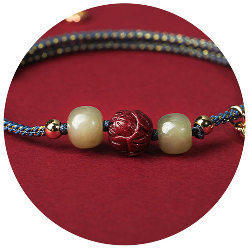 Hetian Jade Cinnabar Lotus Bracelet – Macro detail of lotus cinnabar bead on blue gold cord, close-up beads