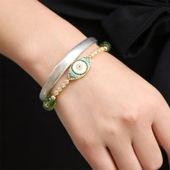 Evil Eye Bundle – Gold evil eye bracelet stacked with silver cuff on wrist, black luxury background