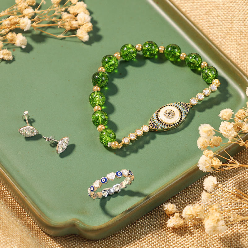 Evil Eye Bundle – Green crackle bead bracelet with pavé nazar eye charm on sage green tray with flowers