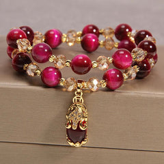 Tiger Eye Pixiu Fox Money Bag Bracelet - double-strand fuchsia tiger eye beaded bracelet with gold crystal spacers and gold-plated crystal-embellished Pixiu charm pendant, magenta cat eye stone, feng shui wealth jewelry
