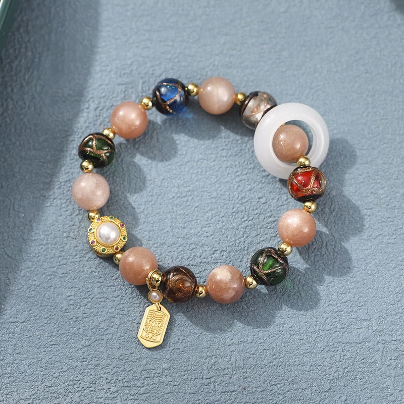 Liuli Glass Prayer Wheel Bracelet – Overhead view revealing sun stone beads and gold charm details