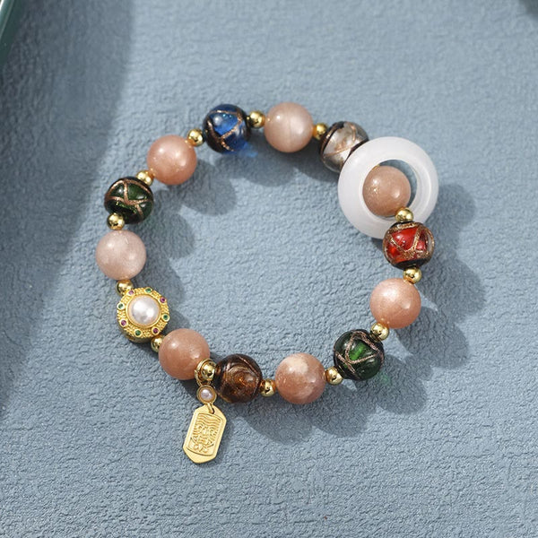 Liuli Glass Prayer Wheel Bracelet – Overhead view revealing sun stone beads and gold charm details