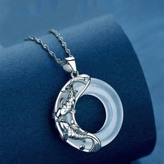 Sterling silver koi fish pendant with white chalcedony circle, detailed twin carp relief carving on circular disc with delicate silver chain