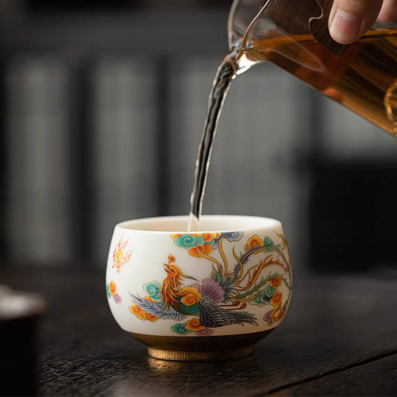 Dragon Phoenix Clouds Ceramic Teacup - Phoenix teacup receiving tea pour on wooden table, auspicious