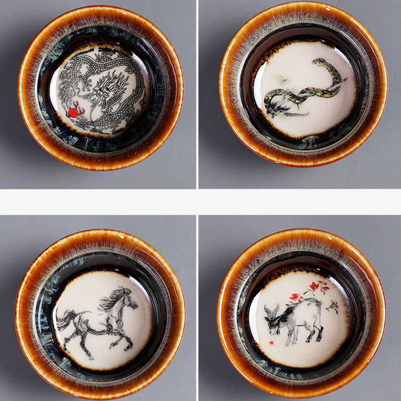 12 Zodiac Jian Zhan Teacup - twelve-cup set on wooden tea tray, hare fur glaze rims and zodiac art, elevated view