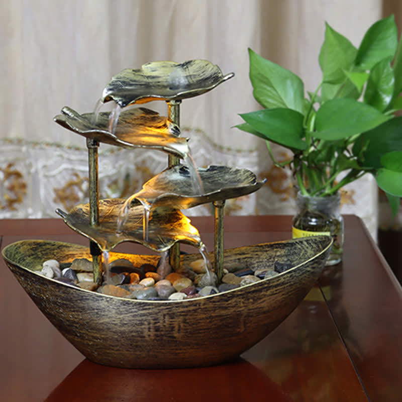 Lotus Leaf LED Waterfall Fountain - warm amber lit bronze fountain with greenery, LED water feature