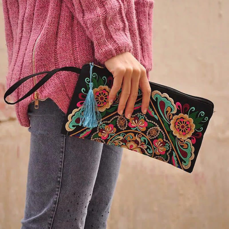 Dragon Butterfly Embroidery Wallet - Model holding clutch with blue tassel, pink knit, Stylish