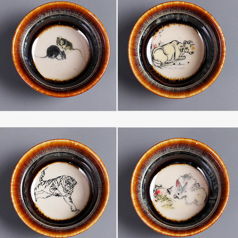 12 Zodiac Jian Zhan Teacup - Monkey Rooster Dog Pig zodiac foursome overhead view, hand-painted ink-wash animal interiors