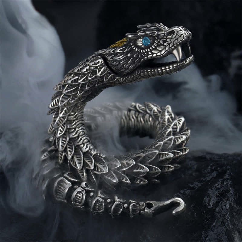 Dragon Snake Copper Bracelet – Articulated dragon cuff with blue gemstone eye on smoky dark background, Powerful