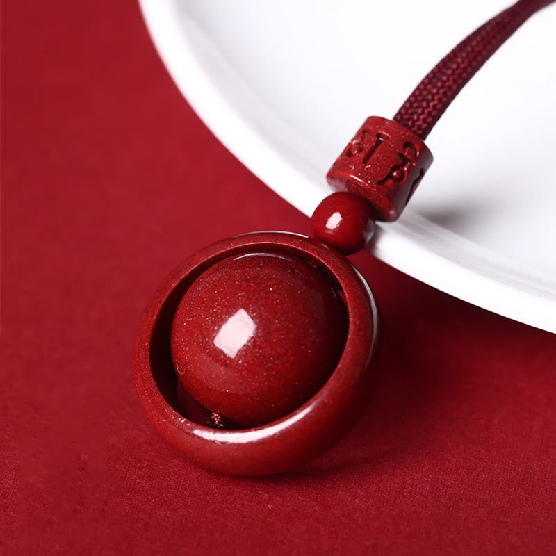 Cinnabar PiXiu Necklace – Leaning on white ceramic plate edge on red surface, Om Mani Padme Hum necklace
