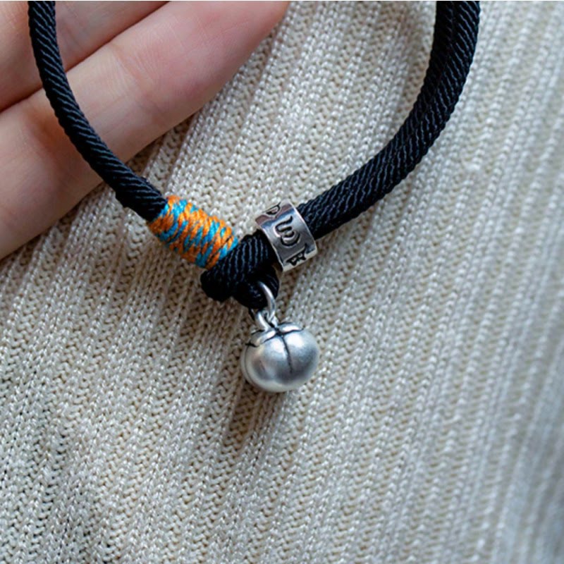 Om Mani Padme Hum Bracelet - Hand-held black cord showing silver gourd charm and mantra bead, artisan jewelry