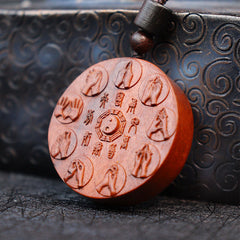 Lightning Struck Jujube Wood Pendant – Circular sandalwood disc with central bagua yin-yang symbol, eight carved mudra hand g