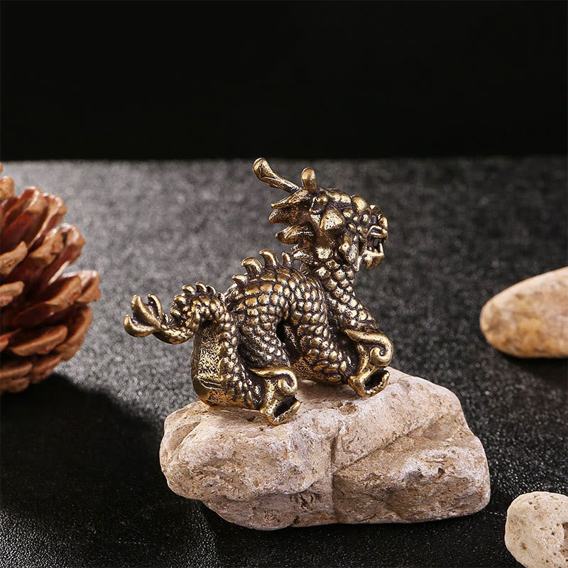 Auspicious Brass Dragon Decoration - Low-angle hero shot of bronze dragon on natural rock, powerful energy