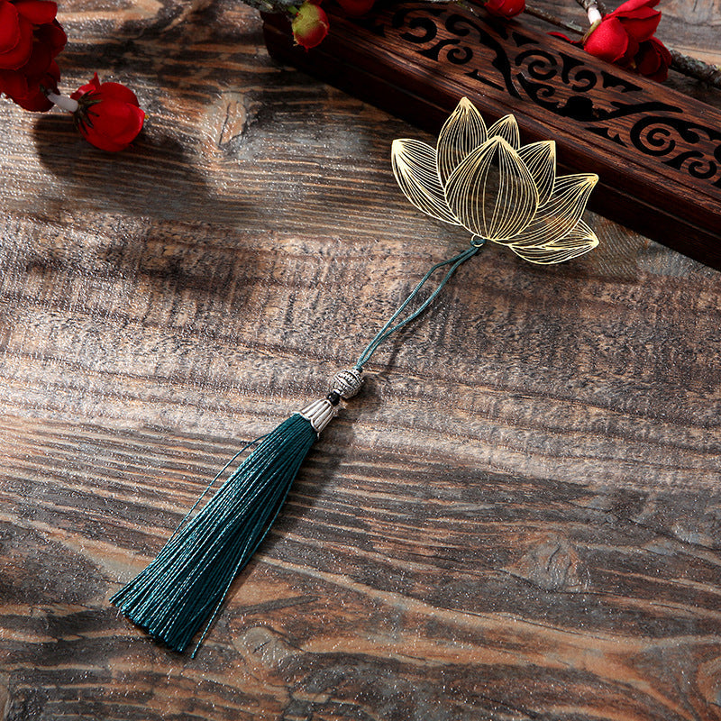 Lotus Brass Hollow Bookmark - golden lotus with teal tassel on weathered wood, elegant gift