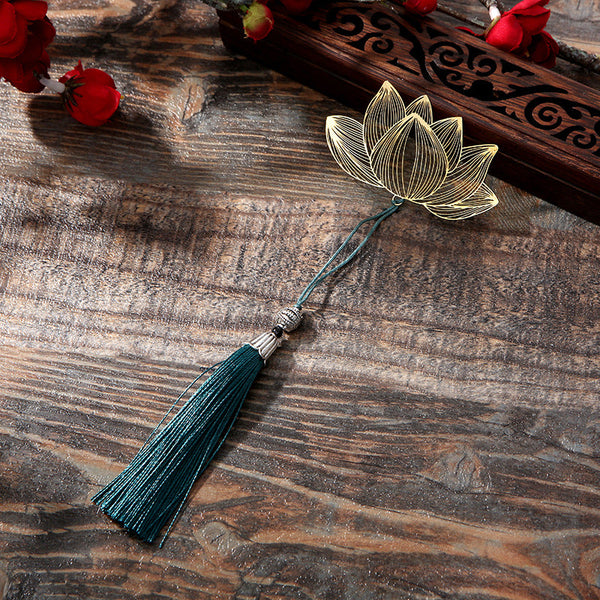 Lotus Brass Hollow Bookmark - golden lotus with teal tassel on weathered wood, elegant gift