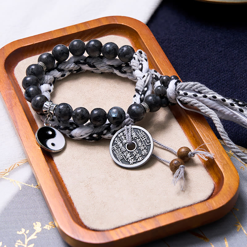 Mountain Ghost Yin Yang Bracelet - woven cord with obsidian beads on wooden tray, wrap bracelet