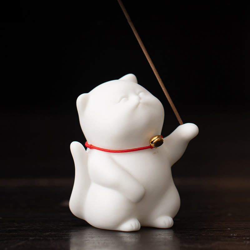 Mini Cute Cat Ceramic Incense Burner – Minimalist chubby white cat with closed eyes on dark surface, aromatherapy decor