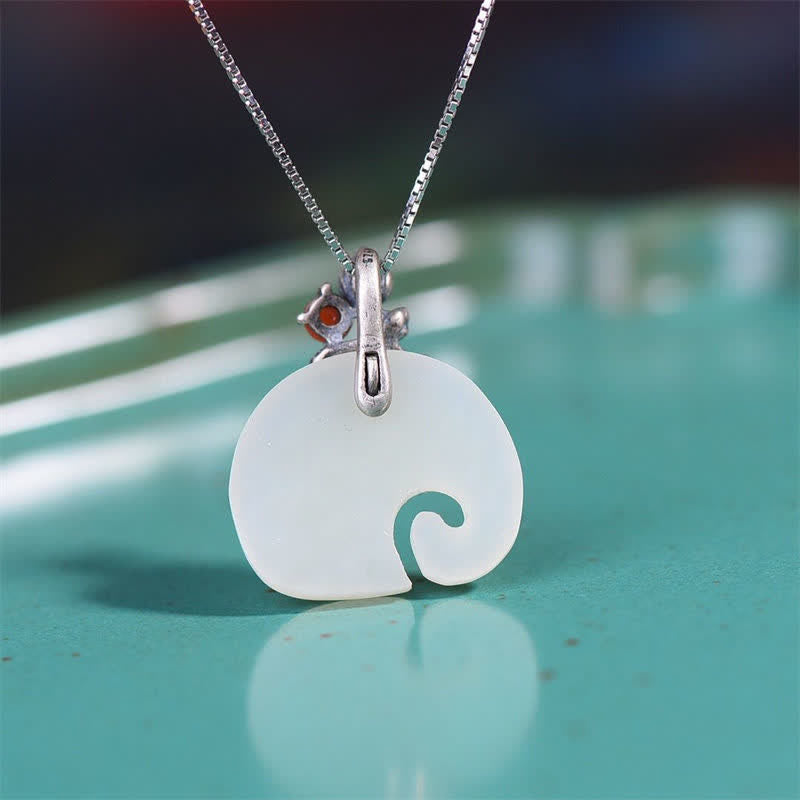 White Jade Elephant Lotus Necklace - Minimalist elephant pendant with curled trunk and red gemstone on silver chain