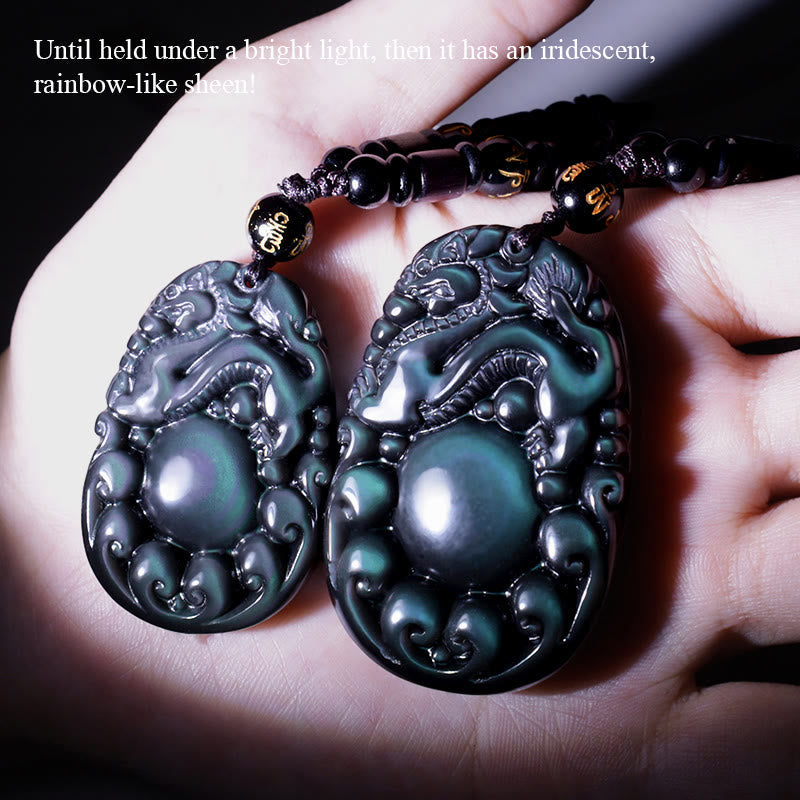 Tibetan Rainbow Obsidian PiXiu Necklace – two PiXiu pendants held in palm showing size and detail, good luck wealth necklace