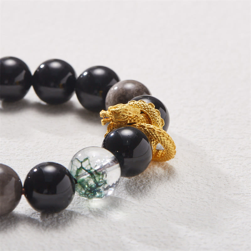 Silver Sheen Obsidian Dragon Bracelet – Macro close-up of coiled gold dragon with green inclusion crystal, powerful