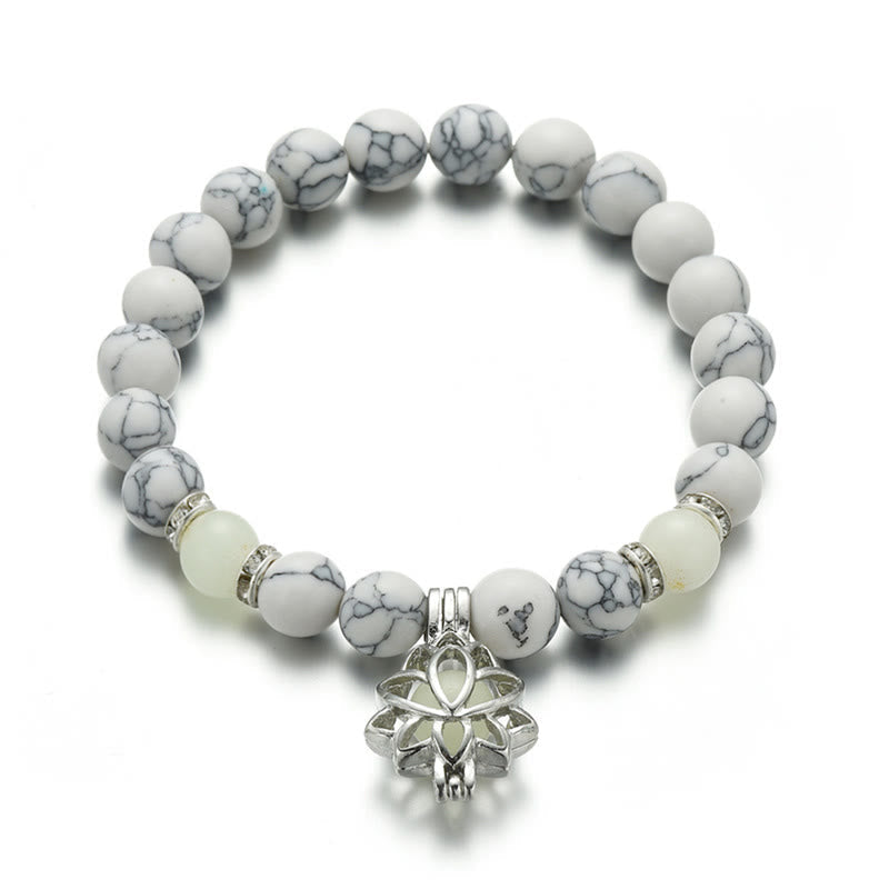 Tibetan Turquoise Glowstone Lotus Bracelet – white howlite beads with pale cream glow beads and lotus charm flat lay, lotus bracelet