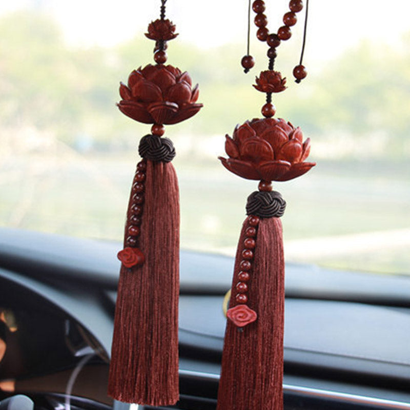 Red Sandalwood Lotus Tassel - two lotus ornaments hanging in vehicle, natural daylight