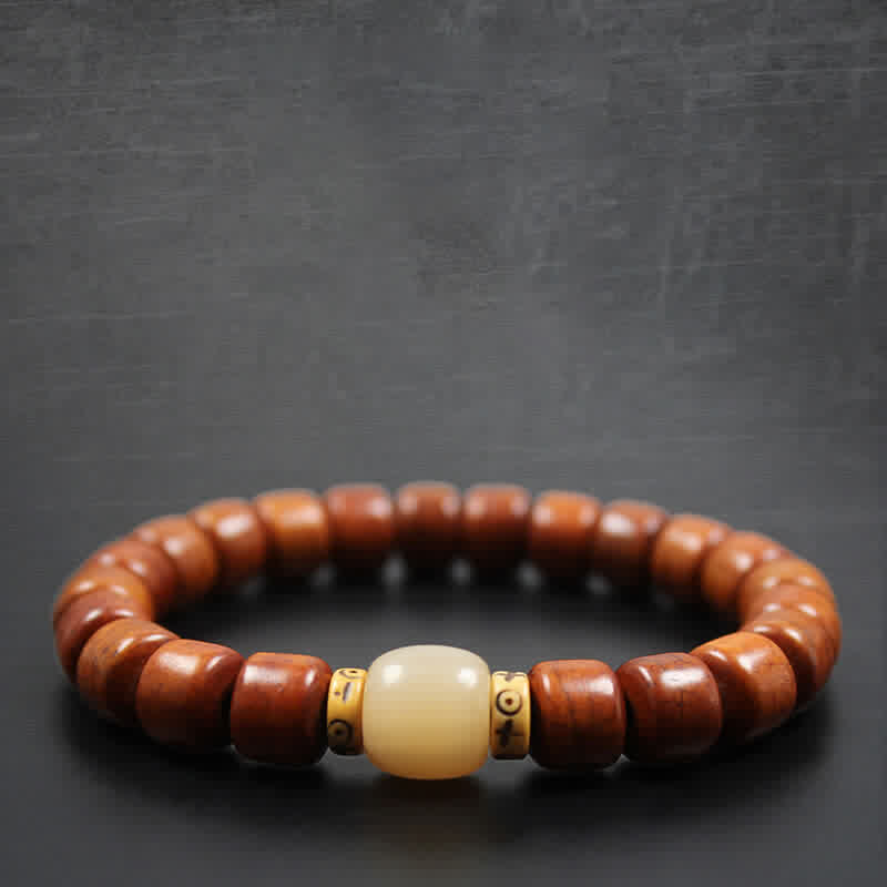 Tibetan Bone Beads Om Mani Padme Hum Bracelet – dark backdrop with cream center bead on wooden prayer bracelet, mala jewelry