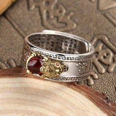 Red Agate PiXiu Wealth Ring – silver PiXiu ring with red agate on wood and antique book, wealth talisman