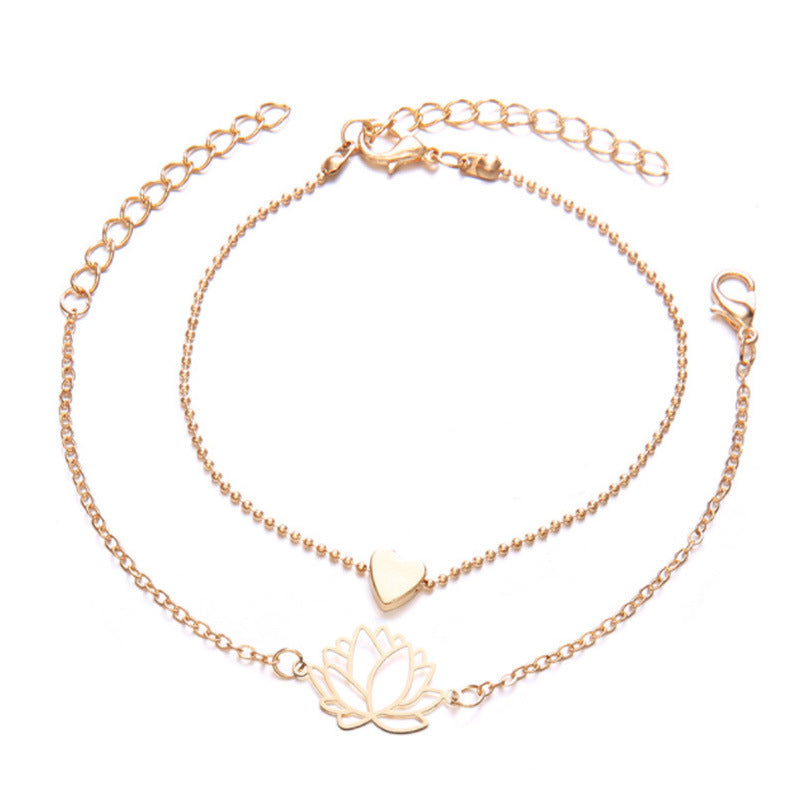 Lotus Heart Enlightenment Bracelet - Two gold layered bracelets with lotus and heart charms on white, love bracelet