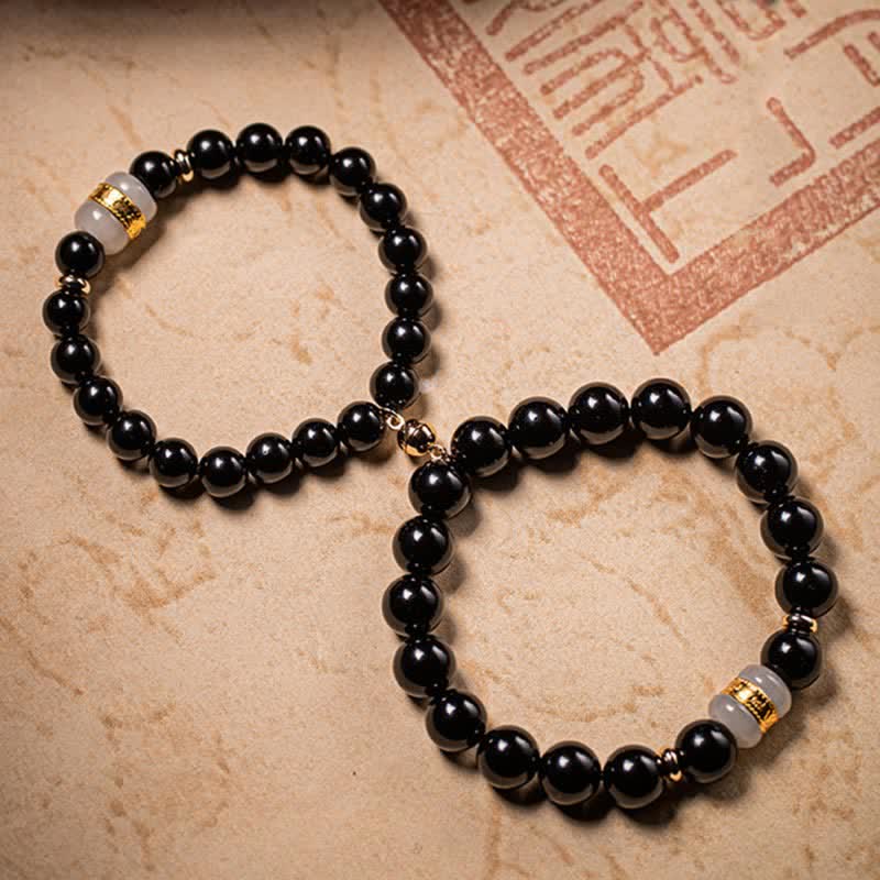 Black Obsidian Jade Bracelet – Two bracelets in infinity layout on aged parchment with cultural seal, couple set