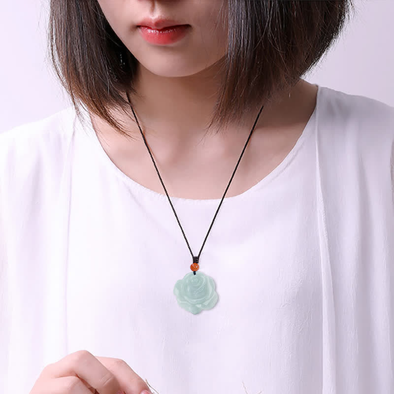 Lotus Pattern Jade Prosperity Necklace - model wearing carved pendant on white top, jade jewelry