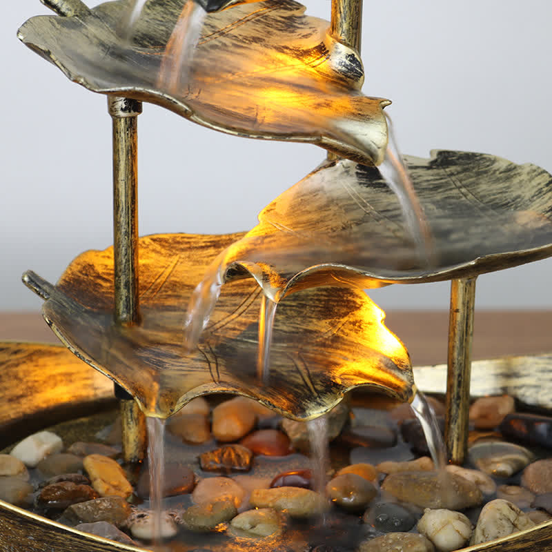 Lotus Leaf LED Waterfall Fountain - close-up golden LED glow through cascading water, illuminated fountain